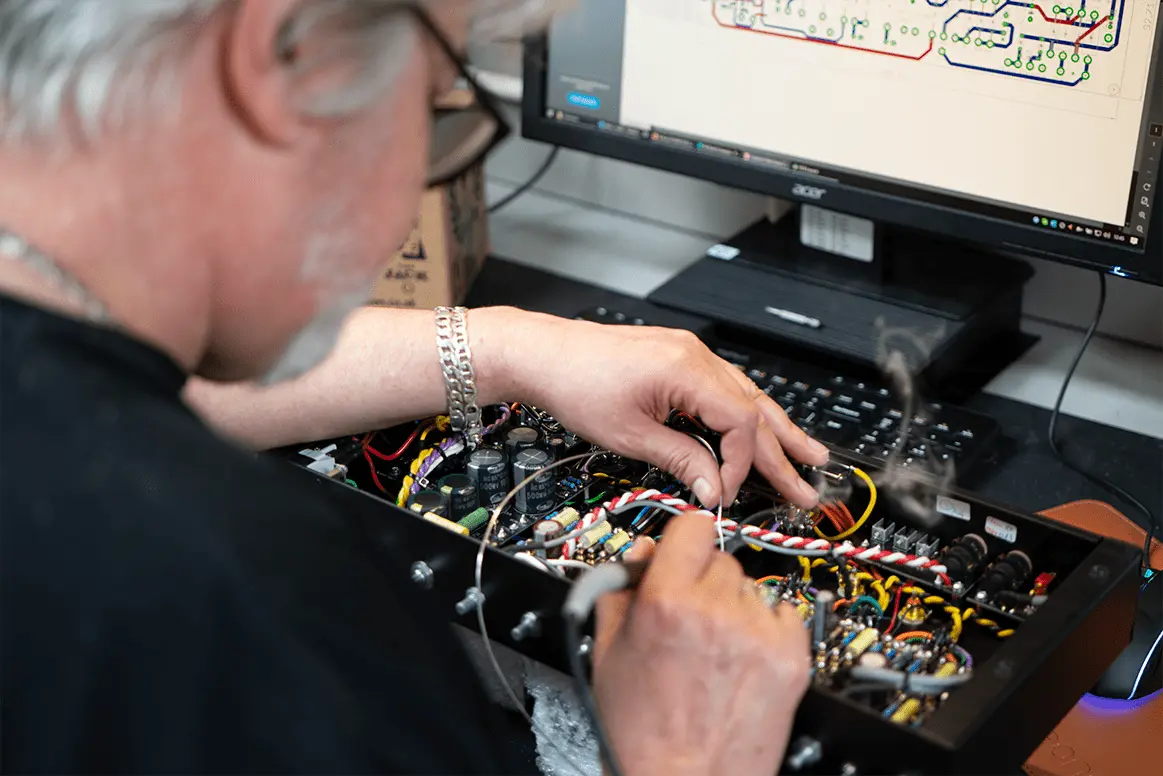 Martin Kidd soldering a hand-wired chassis. Photo: Victory Amplification, the Our Story page
